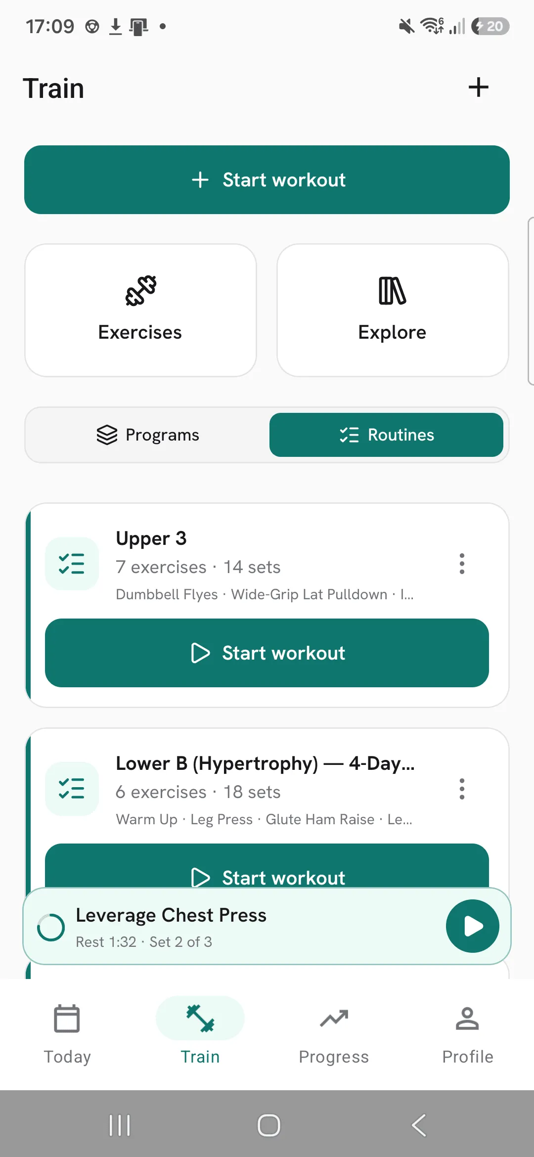 The Train tab with a bar docked above the tab bar for the running workout: Leverage Chest Press, set 2 of 3, with the rest counting down and a button to go back to it.