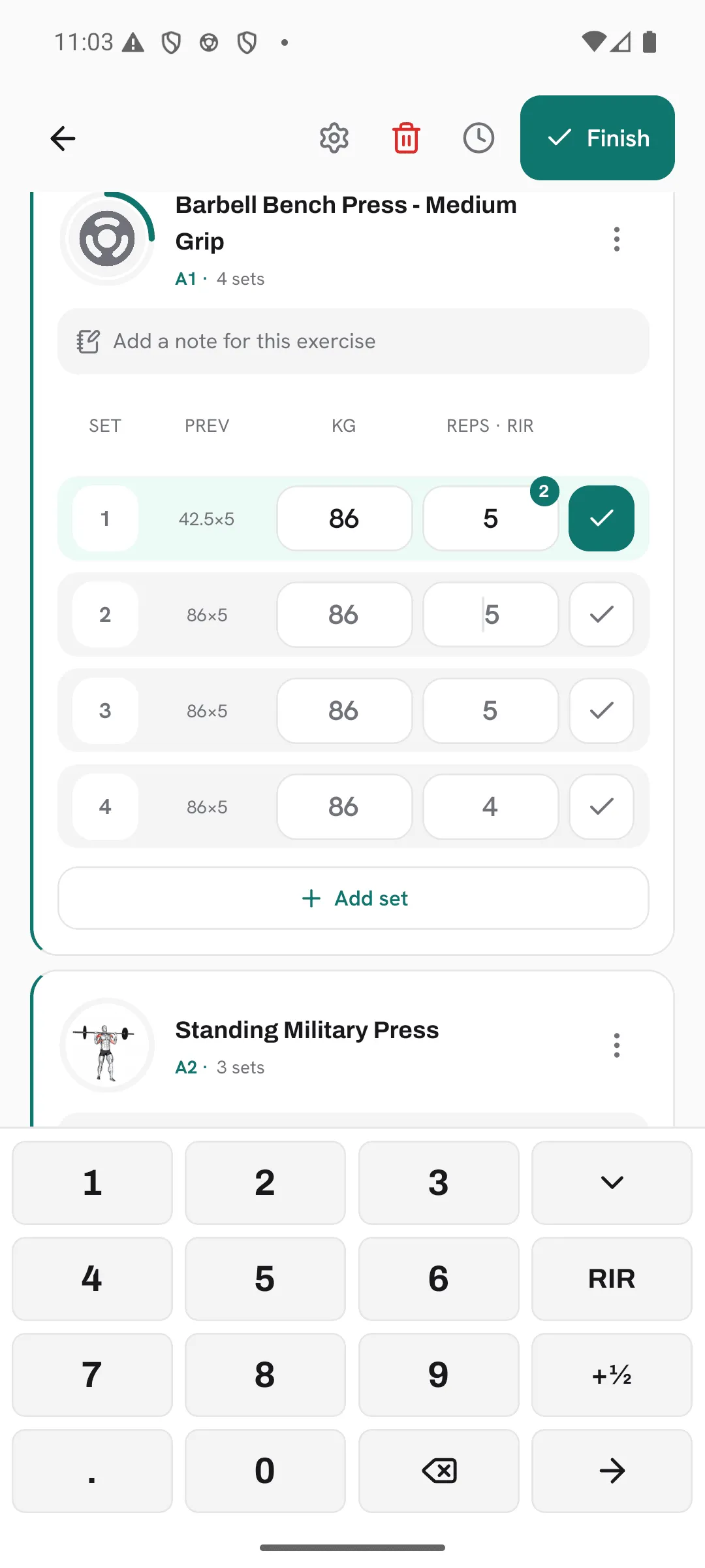 A superset in an active workout with set 1 of A1 ticked and rated RIR 2, and set 2’s reps open on the keypad.
