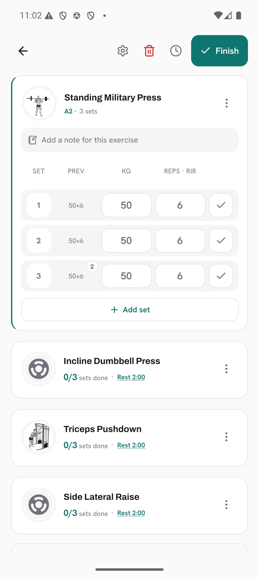 The sets of Standing Military Press in an active workout, where last time’s rating shows as a small 2 tag on a set’s previous values.